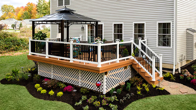 Custom backyard deck with gazebo and white railing — Connecticut carpentry project