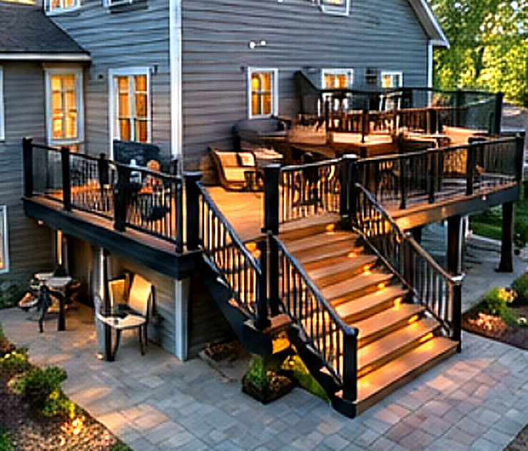 Multi-level deck with under-rail lighting at dusk — Connecticut carpentry project